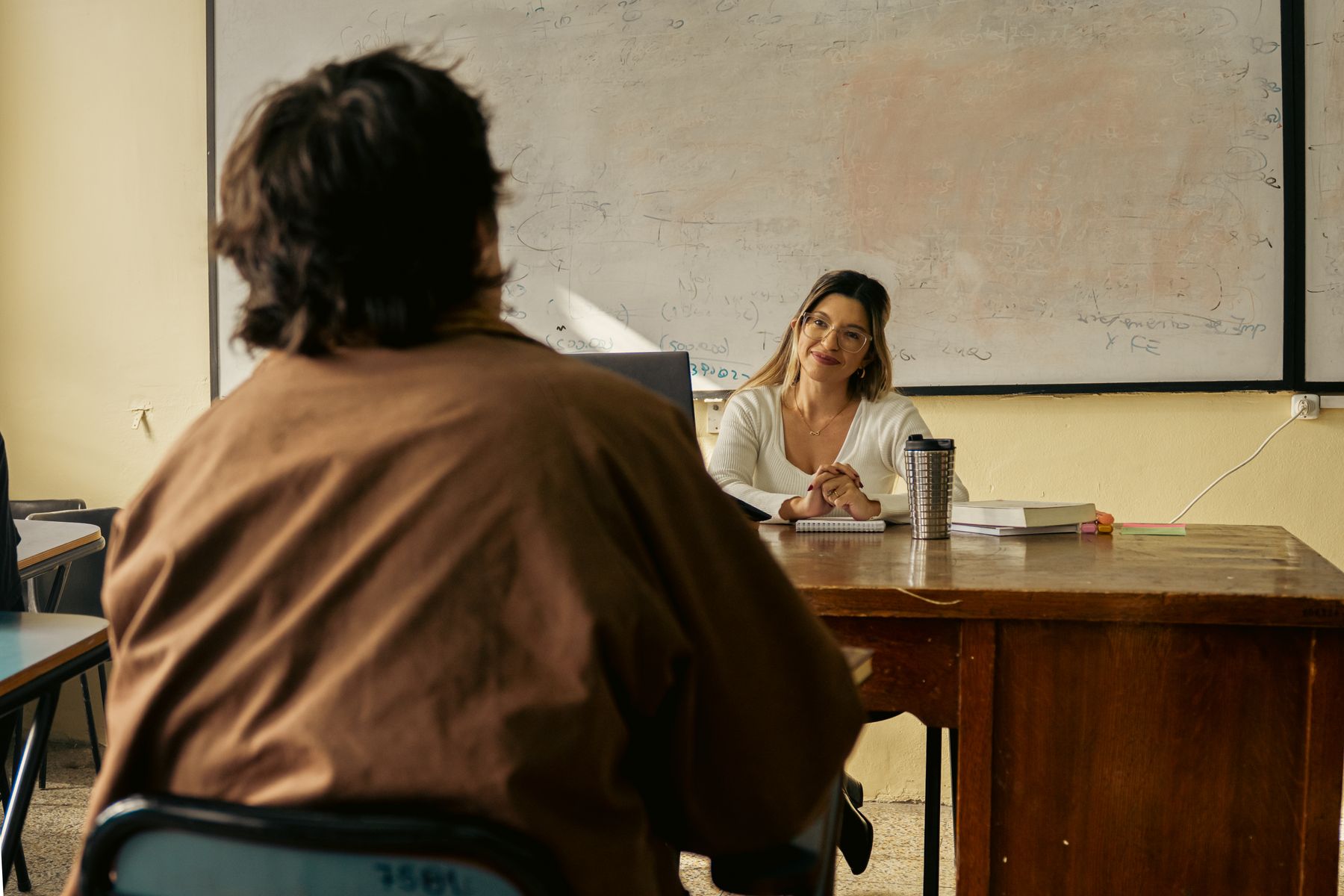 Teacher and adult learner discussing material in a classroom