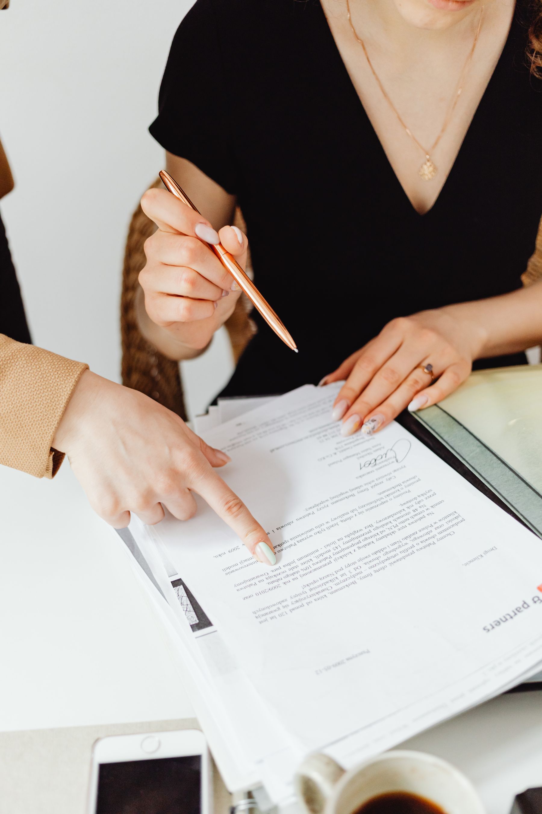 Two people reviewing paperwork together at a service desk