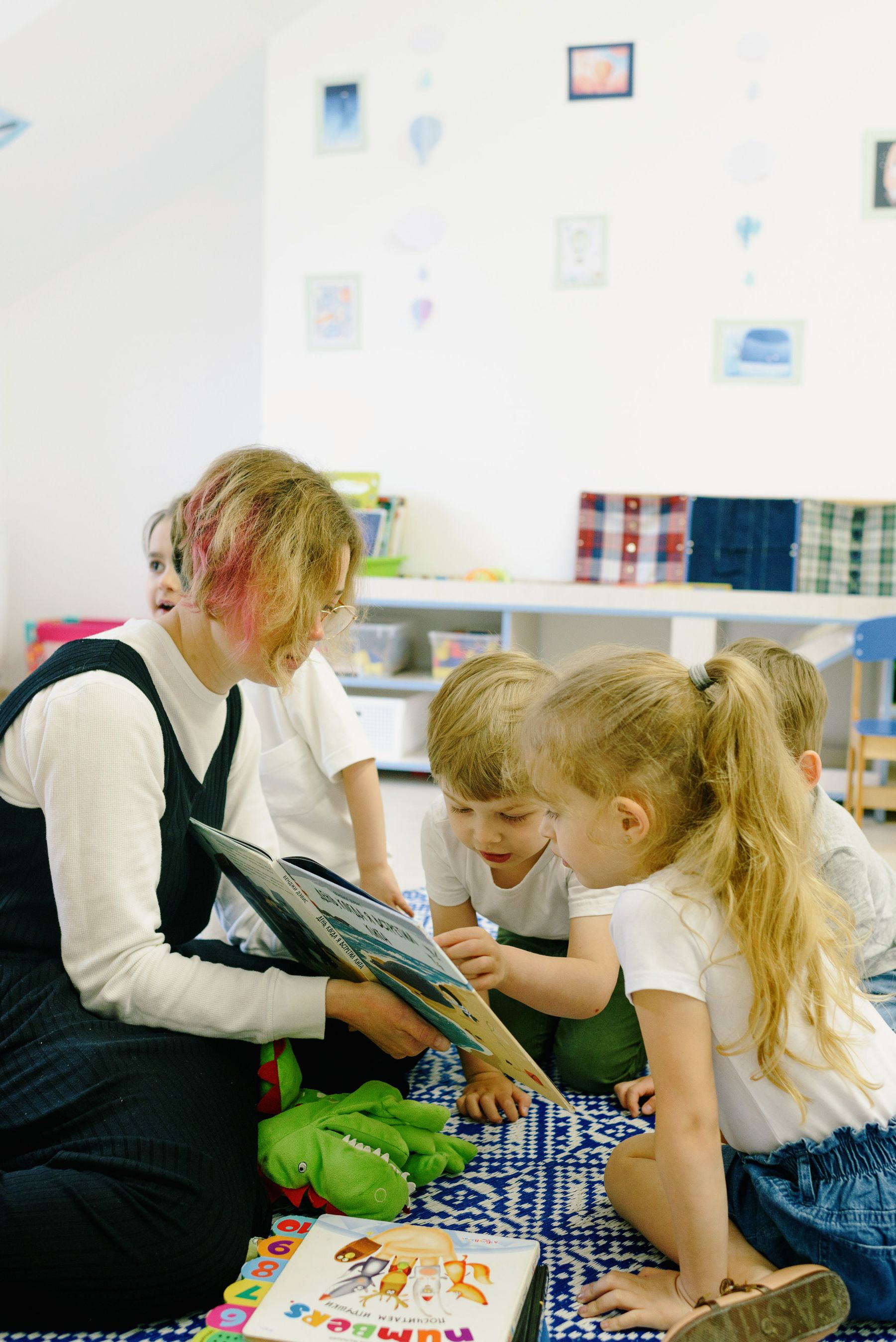Teacher reading with children in a bright classroom storytime session